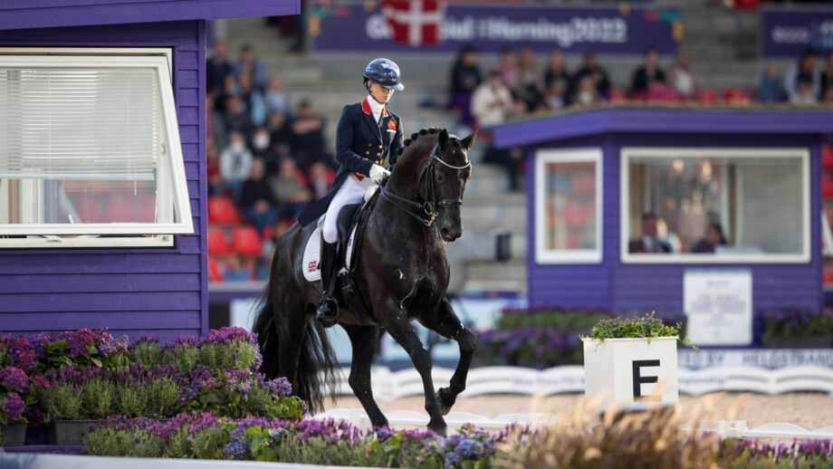 Lottie Fry riding the black stallion Glamourdale in a dressage grand prix test
