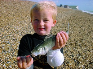 My son Louis with his first ever fish - a bass caught on a shrimp lure. Just make sure all under-sized fish go back.
