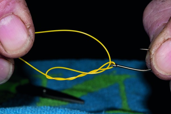 4 Wet the knot and ease the knot down towards the eye of the hook, which will now form a figure of eight.
