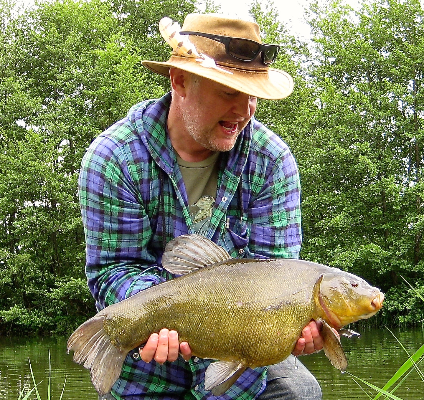 Michael Owen admires the pick of his big tench haul.