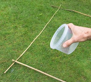 Weigh the appropriate amount of products, make a 1m sq measure with canes, lay it on the lawn and sprinkle evenly over the area. Note coverage, and spread the rest evenly over the whole area at a similar density