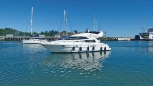 The sleek Astonda39, floating in calm waters in front of a blue sky.