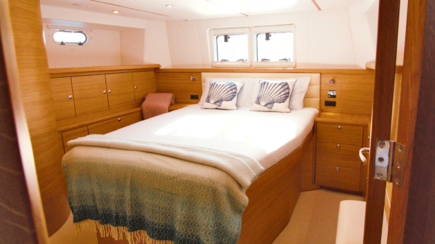 The owner’s aft cabin is lined with oak cabinetry on all sides