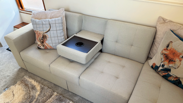The sofa’s folding backrest bceomes a drinks table