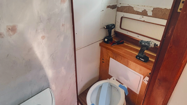 Work begins on the forward heads, replacing the old manual toilet and heavy sliding sink in favour of a modern electric loo, corner sink and shower