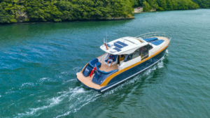 The Rustler 41 in the water with greenery behind