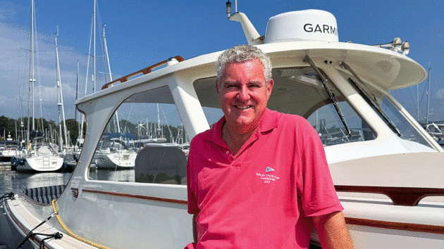 Owner Stuart is delighted with the finished result, sitting on his boat in the sun