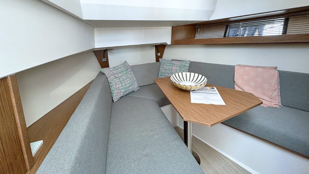 The upper lounge narrows the dinette and drops the deckhead