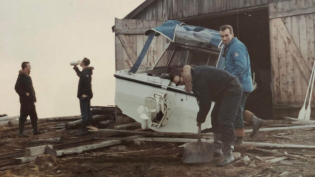 Boat outside a wooden shed
