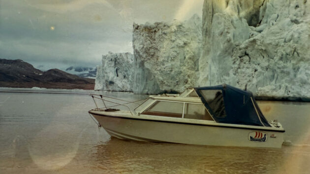 Boat with an iceberg behind