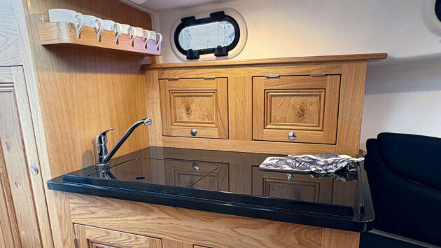 Joinery inside the boat with dark countertop 