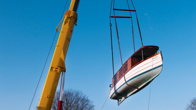 A fully restored Malaya is lifted into the Thames at Lechlade