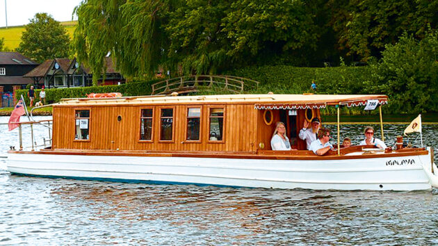 New owner Charles Lyne at the helm of his lovingly restored Malaya