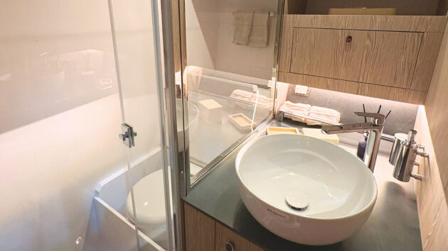 The compact bathroom does provide a separate shower