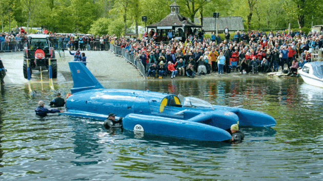 Divers ease Bluebird K7 off her cradle and into Coniston Water