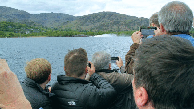 A crowd of onlookers try to capture the moment