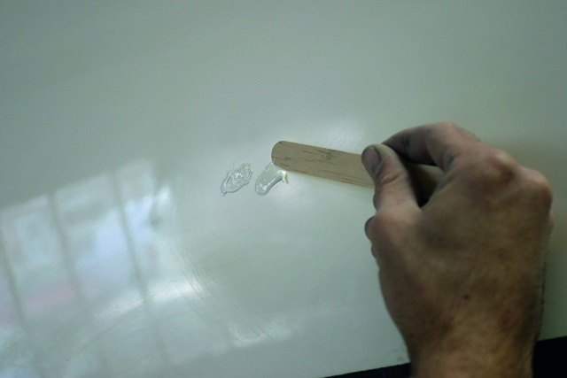 5. Using a mixing stick, place a few dabs of uncatalysed white gel coat onto the hull. These will become your testers (because they haven’t been activated with catalyst, they can later be wiped off with acetone)