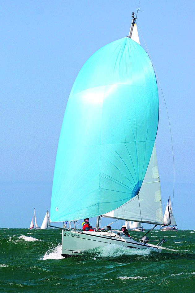  A cruising boat with crew racing at sea