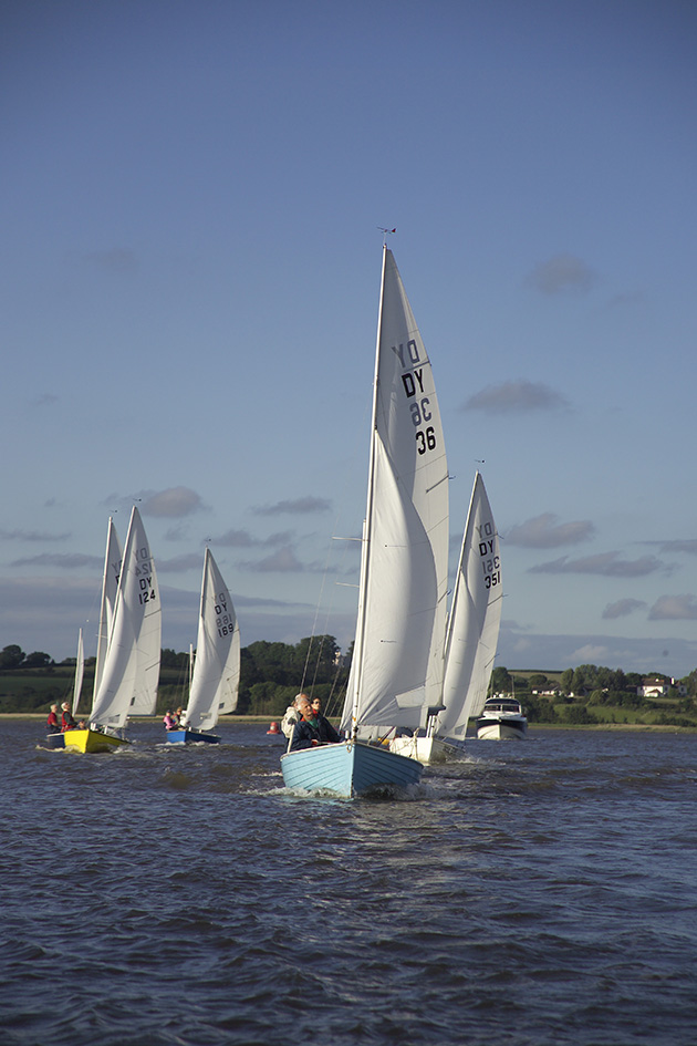 People racing on an estuary in boats