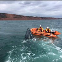 The 18ft powerboat sinking off the Exmouth coast. Credit- Crew volunteer Tim Barnes onboard the R and J Welburn
