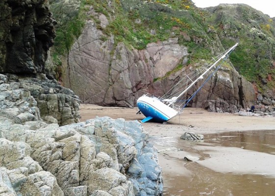 Yacht aground at Lindsway Bay. Credit: Angle RNLI