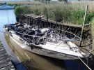 The fire-damaged boat moored near Swineham Point, Wareham