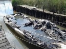 The fire-damaged boat moored near Swineham Point, Wareham