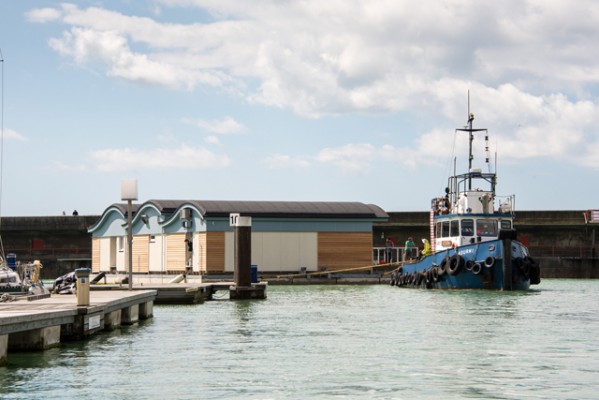 Brighton Marina Yacht Club being towed into position by skilled tug operators. Credit: Julia Claxton Photography