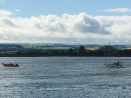 Kessock RNLI's lifeboatt with the stricken yacht under tow. Credit: RNLI/Kessock