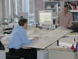 The United Kingdom Hydrographic Offi ce cartographers use computers and massive graphics tablets to create and modify their charts