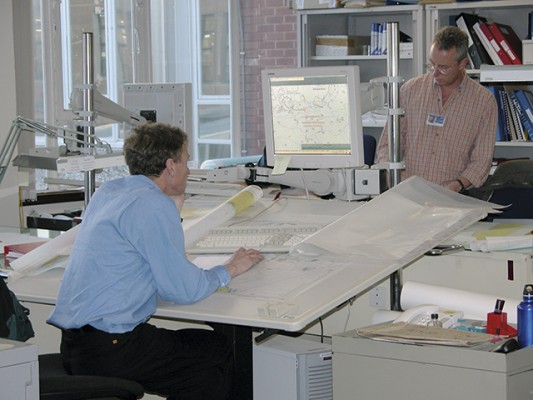 The United Kingdom Hydrographic Offi ce cartographers use computers and massive graphics tablets to create and modify their charts