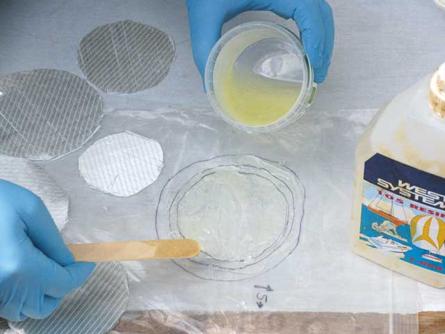 11: Now place the polythene guide on the work table, and lay a fresh polythene sheet over the top so the guide marks show through. Mix up some epoxy, and smear it on to the polythene.