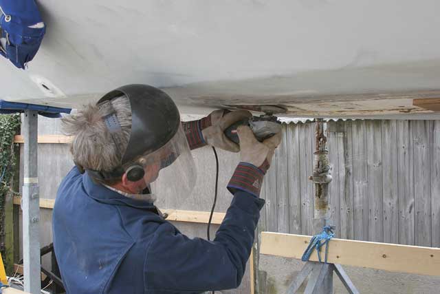 2: He then cleans and smooths the underside of the hull with an angle grinder