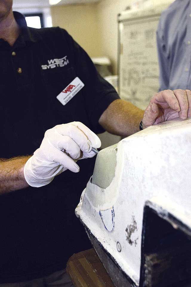 6: Although bigger than the hole, the plate is flexible enough to be inserted behind it and orientated to the correct position. It is then pulled back against the hull using the screw, allowing the five-minute epoxy to take hold. Now tacked into place, the backing plate gives a surface on which to build a repair. The inevitable gaps can be filled with some epoxy thickened with a filling powder.