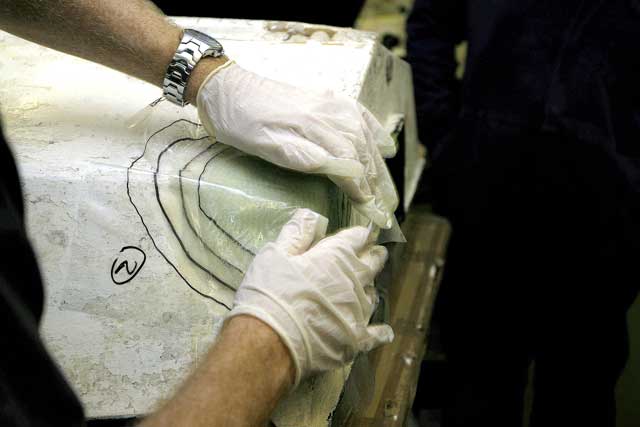 8: The sandwich is laid on to the hull and smoothed into place.