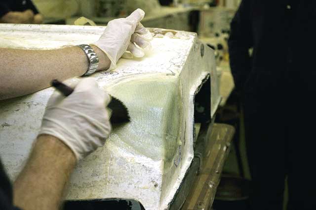 9: The polythene is removed, and a roller is used to smooth it all out. Once cured, the repair will have effectively rebuilt the hull thickness. The final stage is to smooth the repair over with a sandable filler, building the filler slightly proud. Using an orbital sander, this is then taken back until absolutely flush. The repair can then be painted.