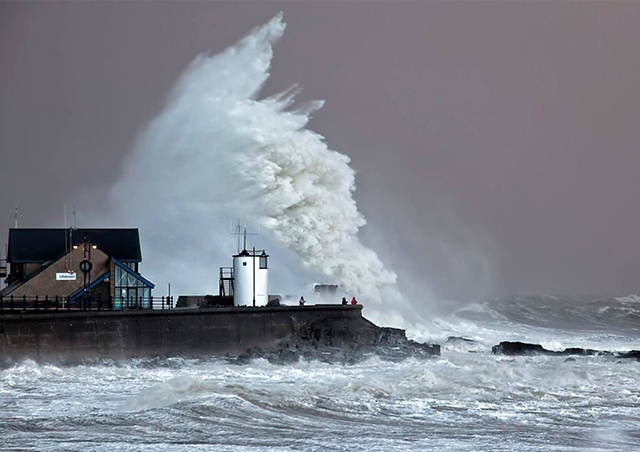 Storm Imogen - photo taken at 8am of a wave breaking over the pier behind Porthcawl RNLI. Credit: Steve Jones