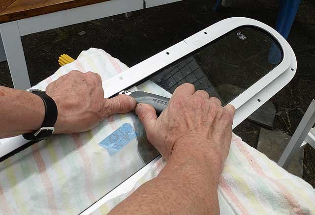 Cutting into the old butyl with a sharp blade