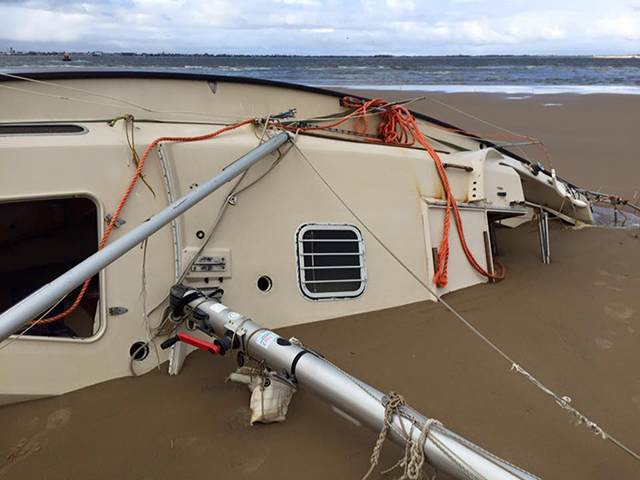 A yacht abandoned by a Russian sailor who was rescued in storms off the coast of Norfolk is still beached at Scroby Sands - three months later. Credit: Caister Lifeboat