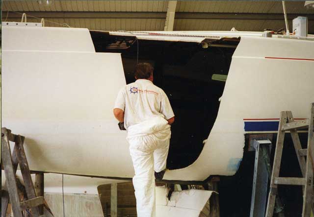 2The first job is to cut away all the damage to beyond the last of the stress cracks. A fine soot is used to trace where the hairline cracks finally end. Note how all the antifouling has been stripped for some distance each side of the damage. To get to the hull, much of the internal furniture in this section had to be disassembled.