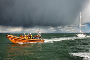 Poole inshore lifeboat towing in the yacht with the poor weather approaching. Credit: Paul Glatzel