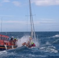 Ramsey RNLI Lifeboat and the stricken yacht. Credit RNLI/Tony Radcliffe