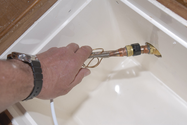 Pass the couplings through from the inside of the coolbox, taking care not to kink the pipes