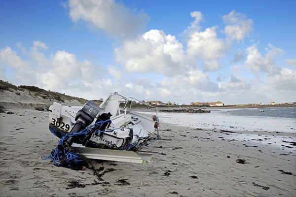 Small power boat wrecked at Le Picquerel. Credit: Peter Frankland