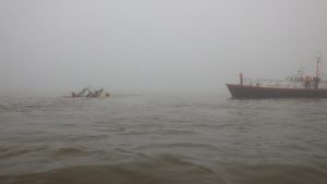 The Pilot Boarding Vessel Venus alongside the sinking motor vessel, and Cleethorpes RNLI recovering the liferaft. Credit: RNLI Cleethorpes