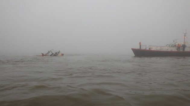 The Pilot Boarding Vessel Venus alongside the sinking motor vessel, and Cleethorpes RNLI recovering the liferaft. Credit: RNLI Cleethorpes