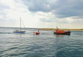 Exmouth's Shannon lifeboat towing yacht with D class alongside. Credit: RNLI/Emma Tarling
