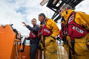 Sir Ben Ainslie with Bembridge RNLI crew members. Credit: RNLI/SVYC/Harriet Hadfield