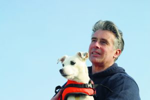 Dave Selby in blue jumper with his dog. He will be speaking at the London Boat Show