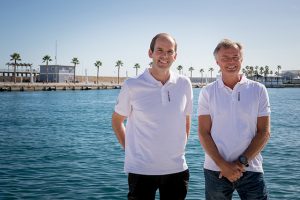 The new leaders of the Volvo Ocean Race dressed in white polo shirts standing next to water